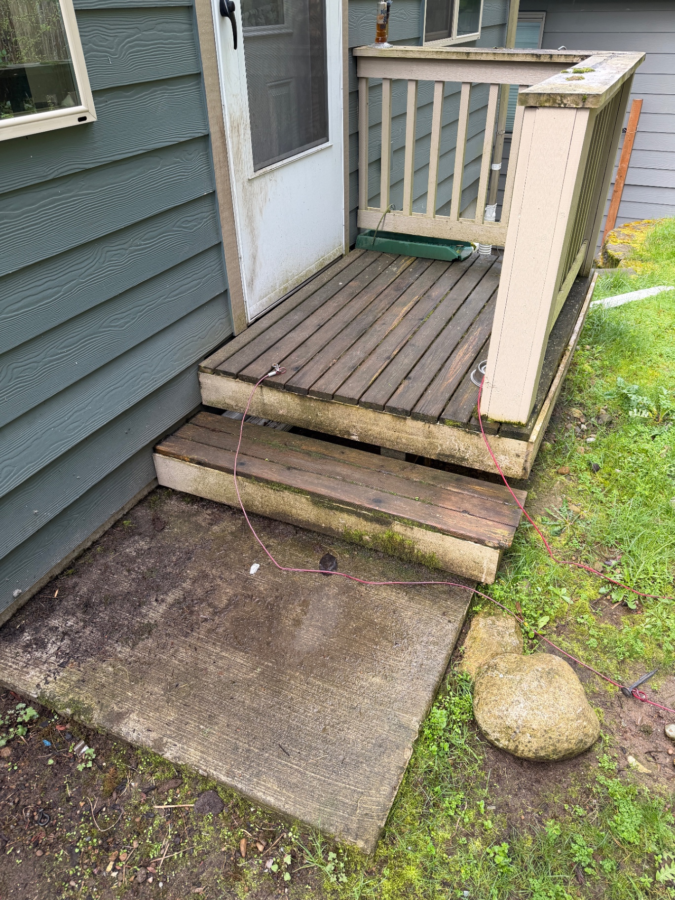 Dirty deck and siding before pressure washing